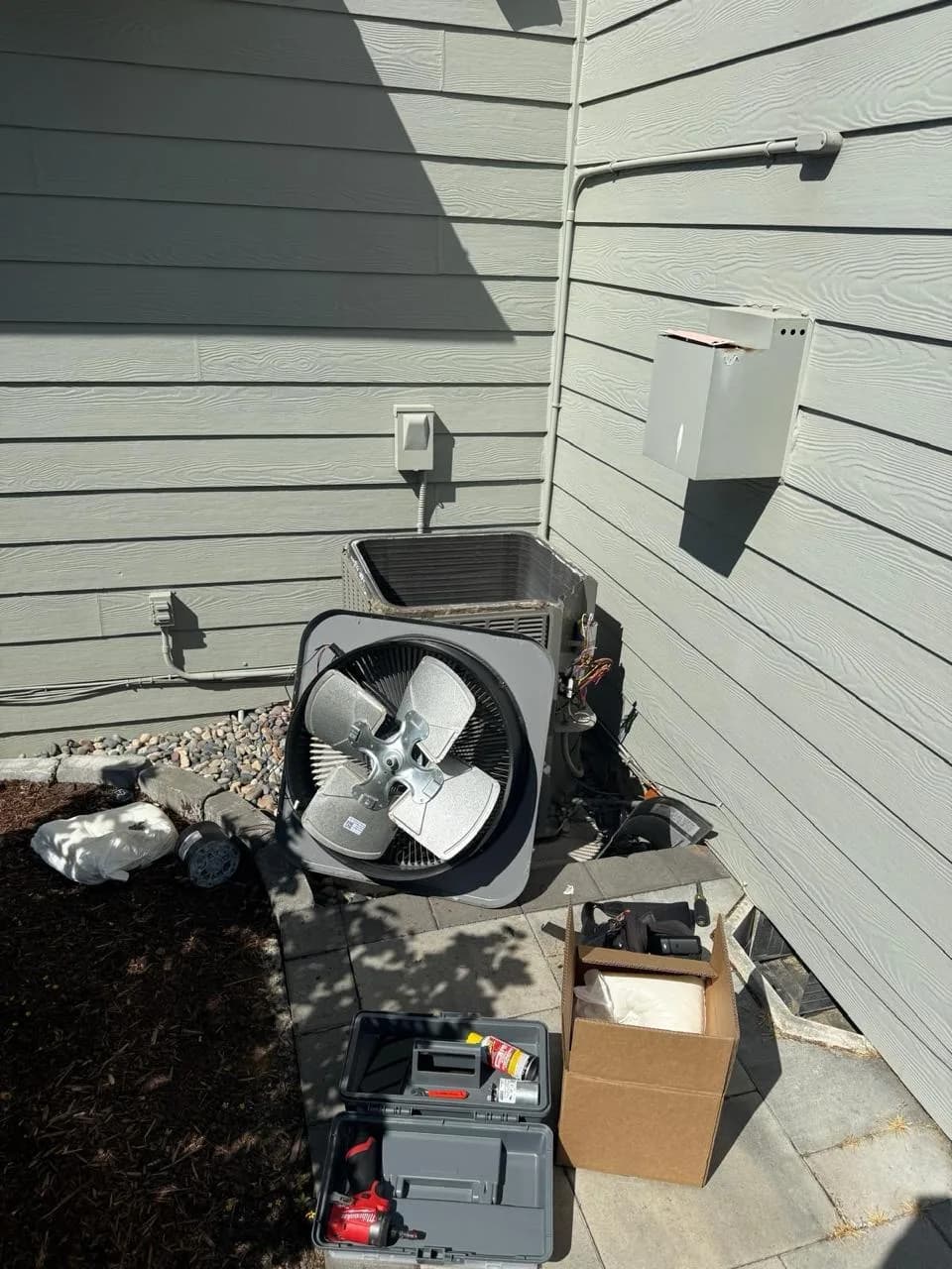 HVAC technician replacing a seized condenser fan motor on an outdoor AC unit in Vancouver, WA