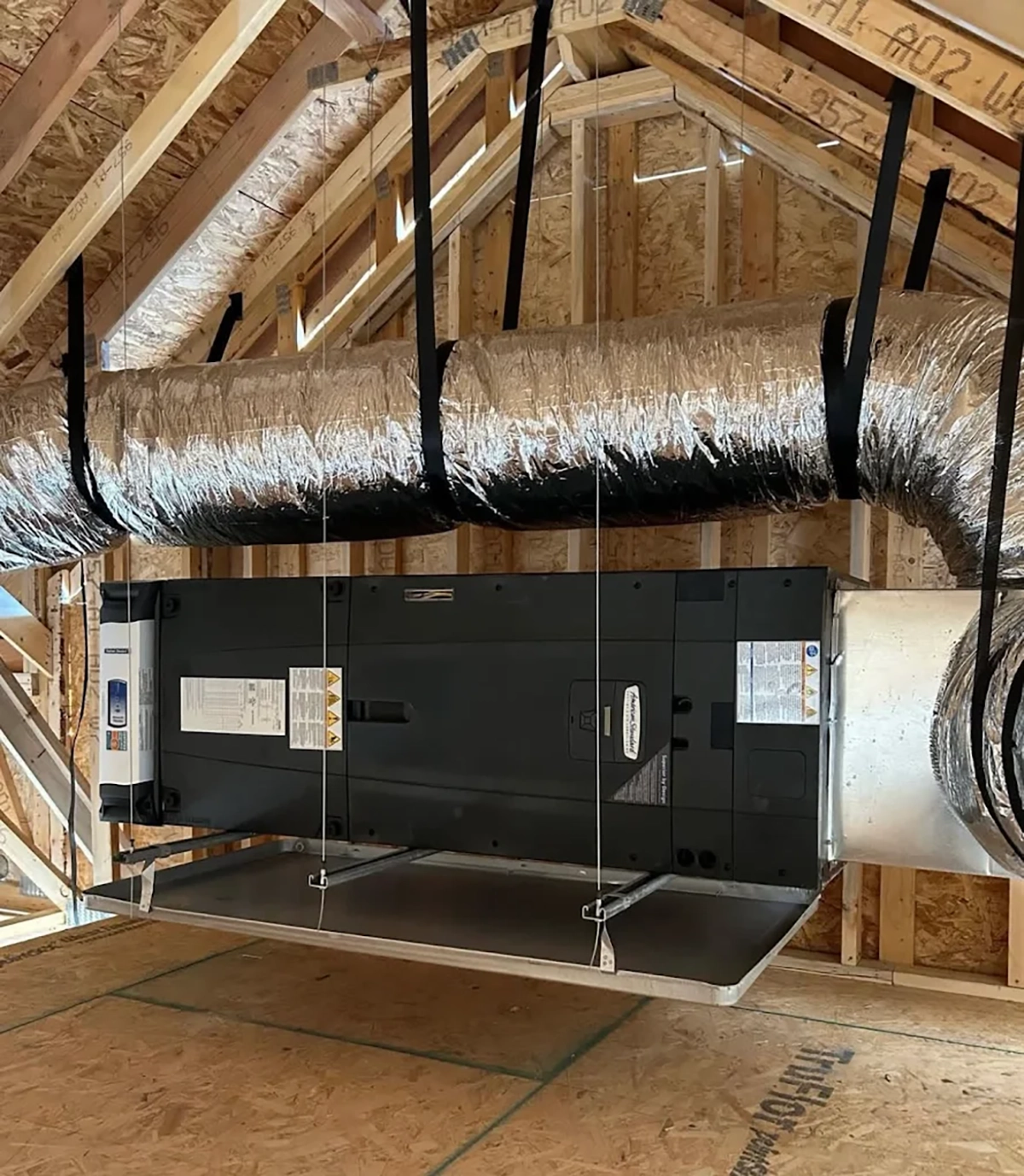 Professional HVAC installation in progress in a Portland home attic with new ductwork and air handler installed by Sub Zero Temp Control.