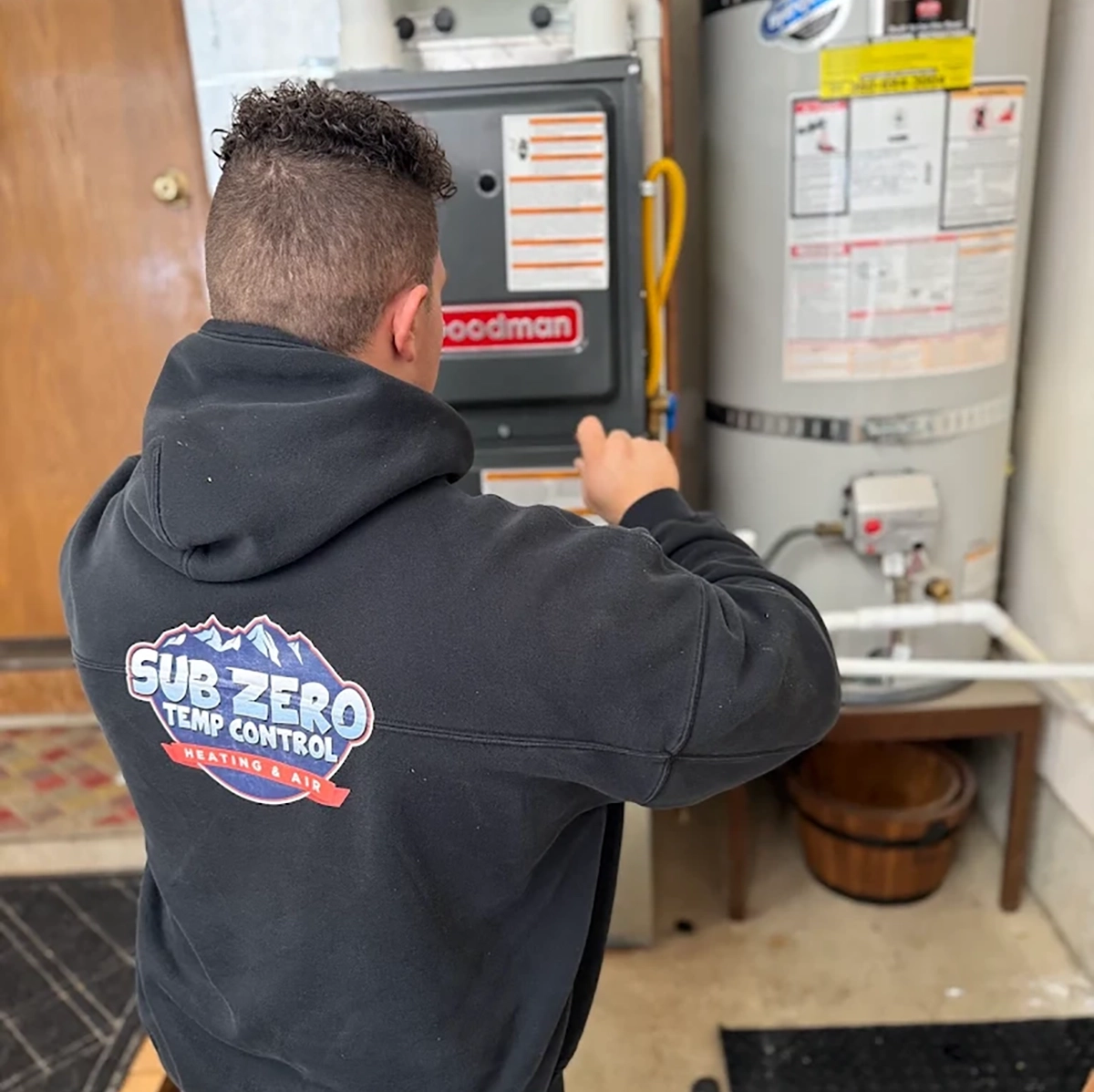 Technician performing furnace repair in Vancouver WA — Sub Zero Temp Control heating expert servicing a Goodman unit.