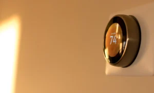 Smart thermostat displaying home temperature during routine HVAC operation