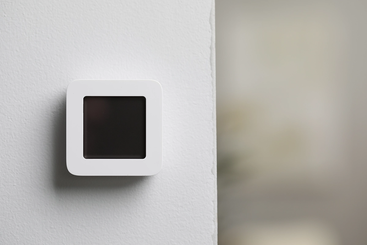 Square wall-mounted thermostat with a blank screen showing no power reaching the thermostat