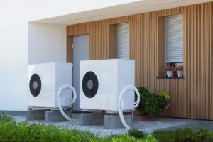Outdoor heat pump units installed beside a residential home
