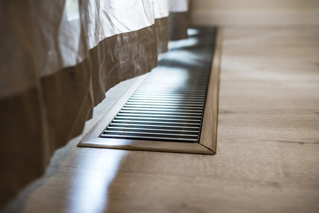Floor air vent delivering warm air as part of a forced air heating system in a home