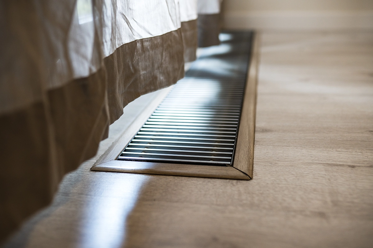 Floor air vent delivering warm air as part of a forced air heating system in a home