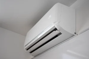 Wall-mounted ductless mini split indoor air handler delivering conditioned air