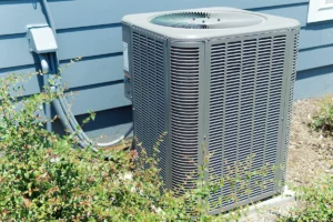 Residential outdoor air conditioning condenser unit near home experiencing AC short cycling symptoms