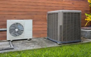 Mini split vs central air outdoor units side by side, showing a ductless mini split condenser next to a central AC condenser for system comparison