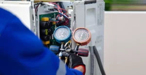 Technician checking R410A refrigerant pressure on a residential air conditioning system